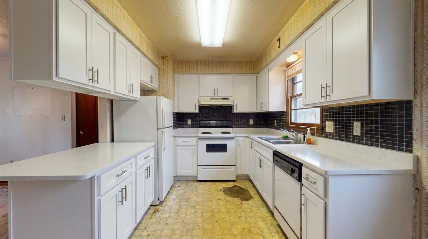Virtually renovated kitchen with white cabinets and quartz countertops
