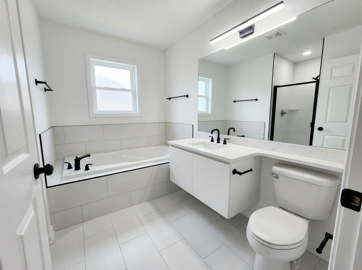 Modern bathroom with white tile and matte black fixtures